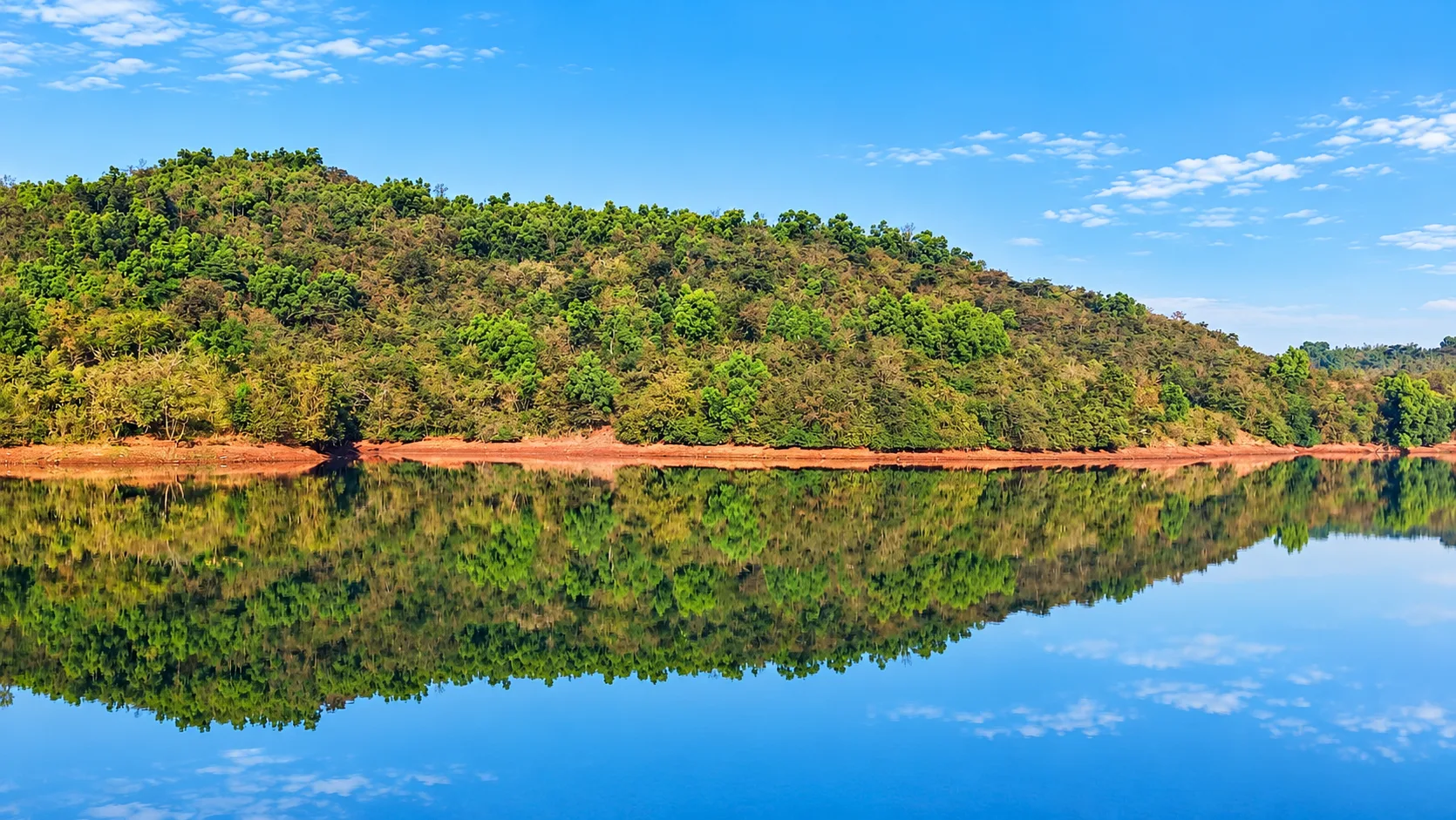 Hills rising behind Viva Andur lake view farmhouse near Gaganbawada